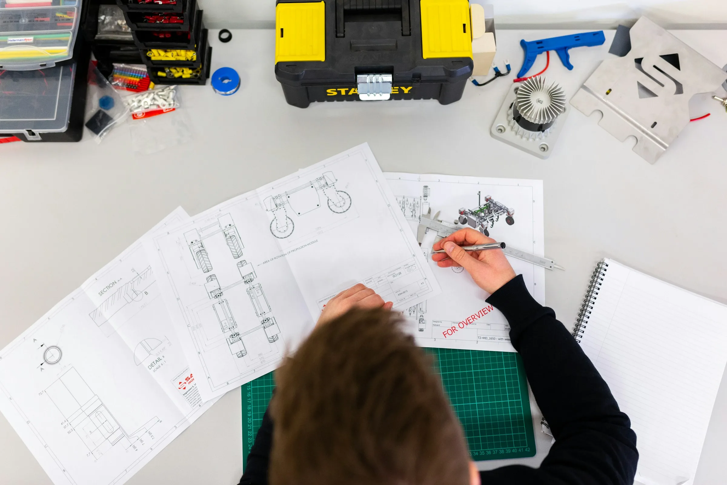 Engineer reviewing technical drawings and engineering specifications