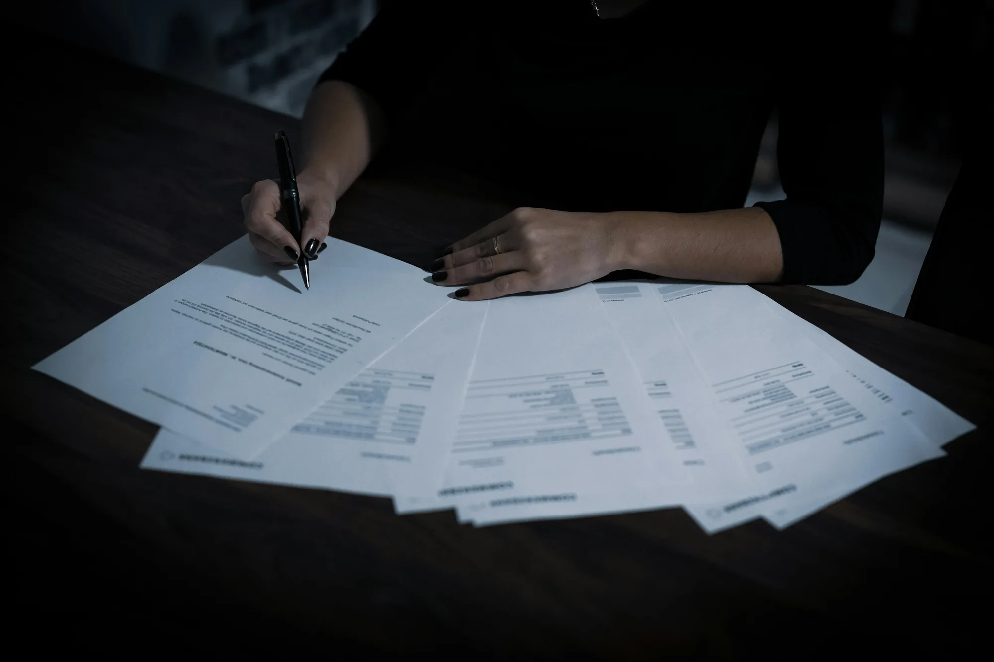Reviser checking documents with a pen