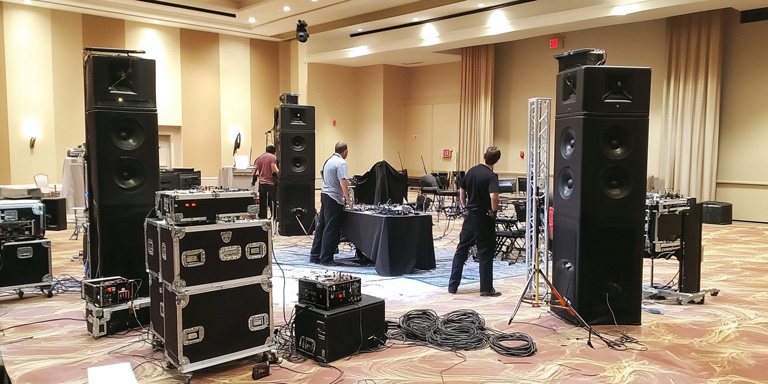 krollkrox_Photo_of_event_setup_with_technicians_arranging_sound_d5cea321-3f03-4b6c-a827-20e118fd9bae